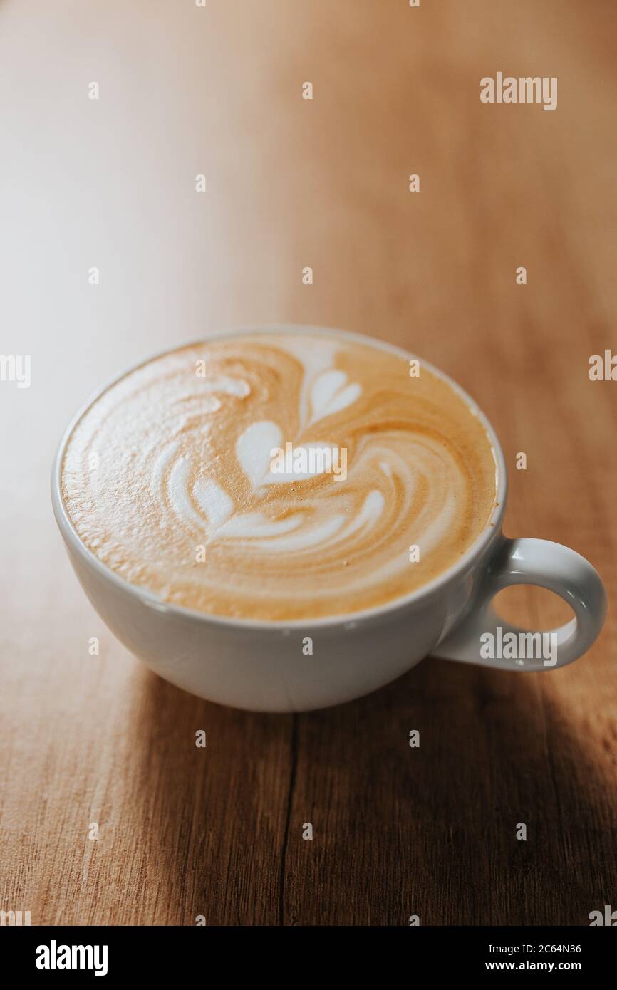 The Art Of Drawing On Milk Foam When Making Latte And Cappuccino In A White Cup On A Bar Table Stock Photo Alamy