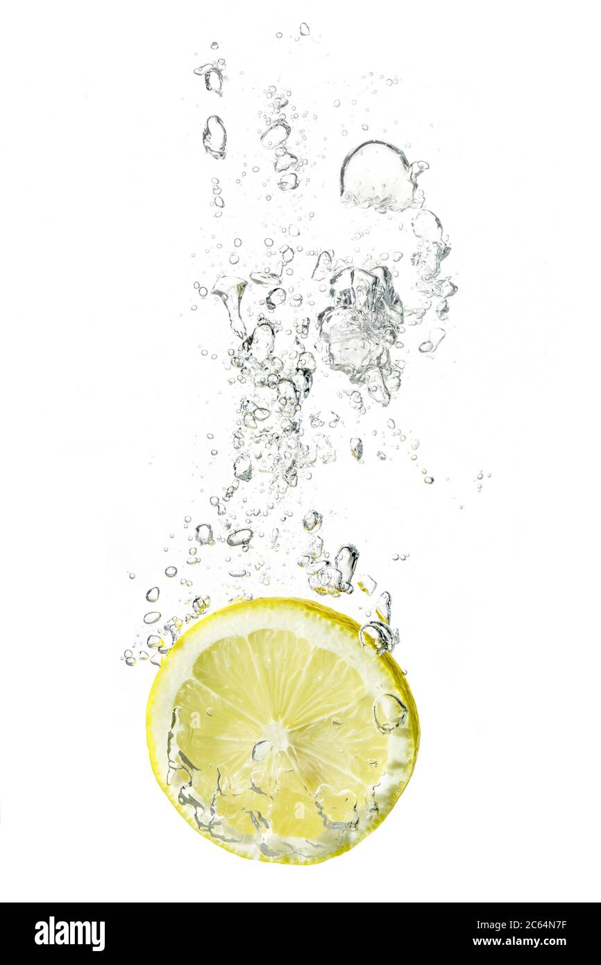 lemon slice dropped into water with bubbles Stock Photo