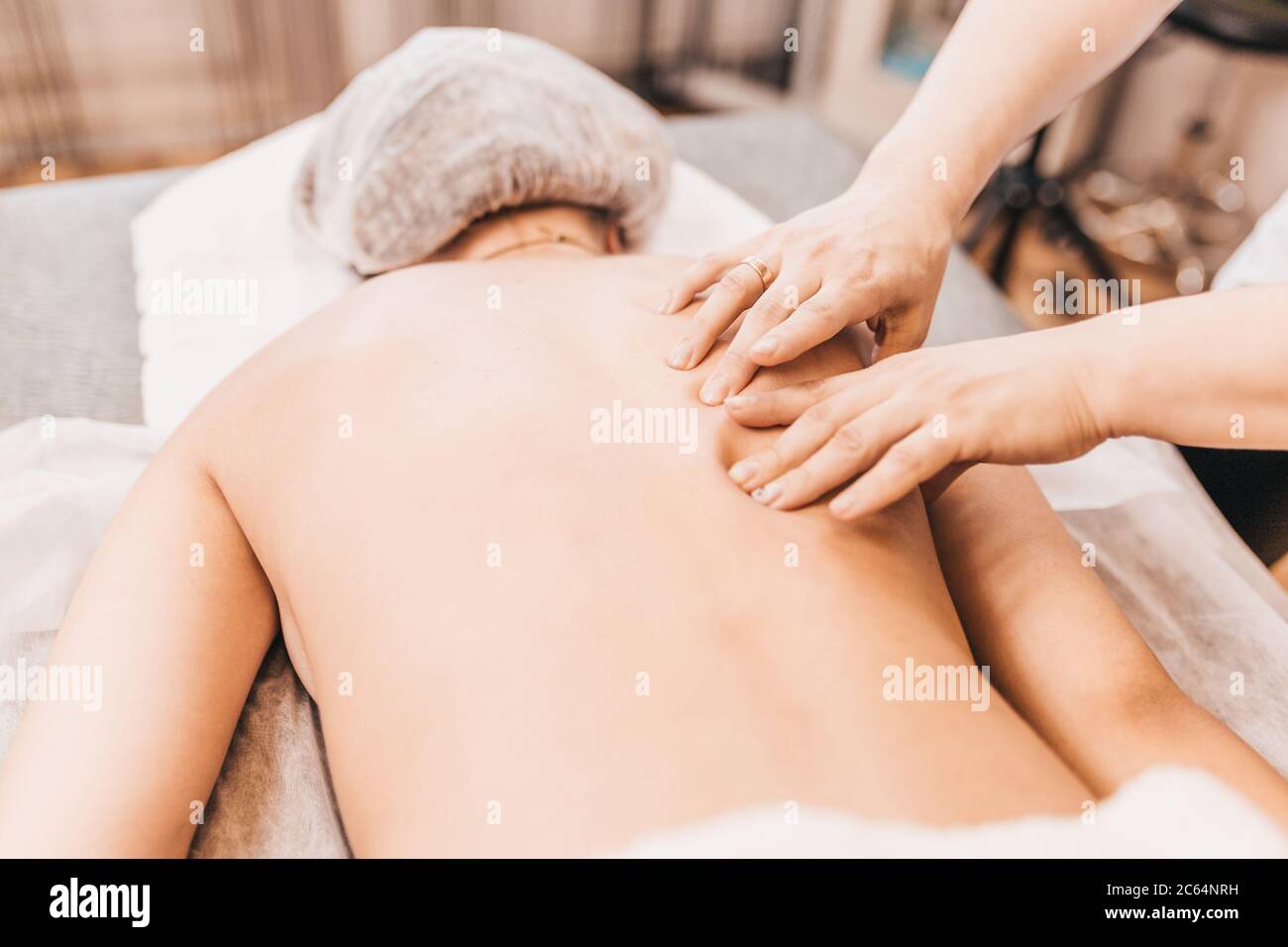 Treatment of pain and muscle spasm in the shoulder - sports traumatology - medical massage Stock Photo