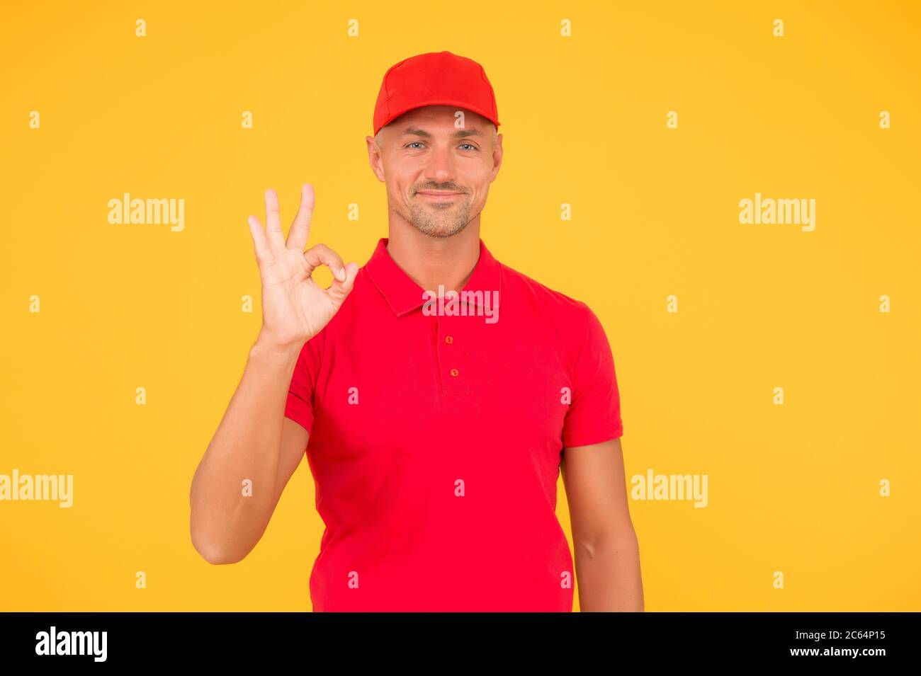 Free services. Freight transportation. Perfect delivery. Delivery man yellow background. Express delivery courier service. Parcel post package. Delivery copy space. Cashier shop staff. Black friday. Stock Photo