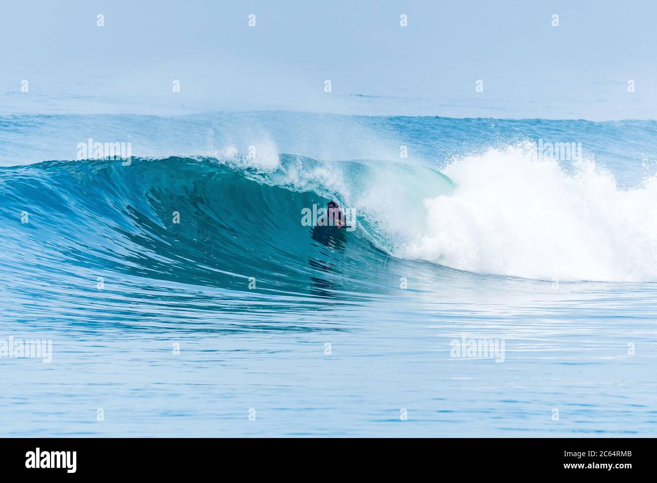 Bodyboarder surfing ocean wave on a sunny day Stock Photo - Alamy