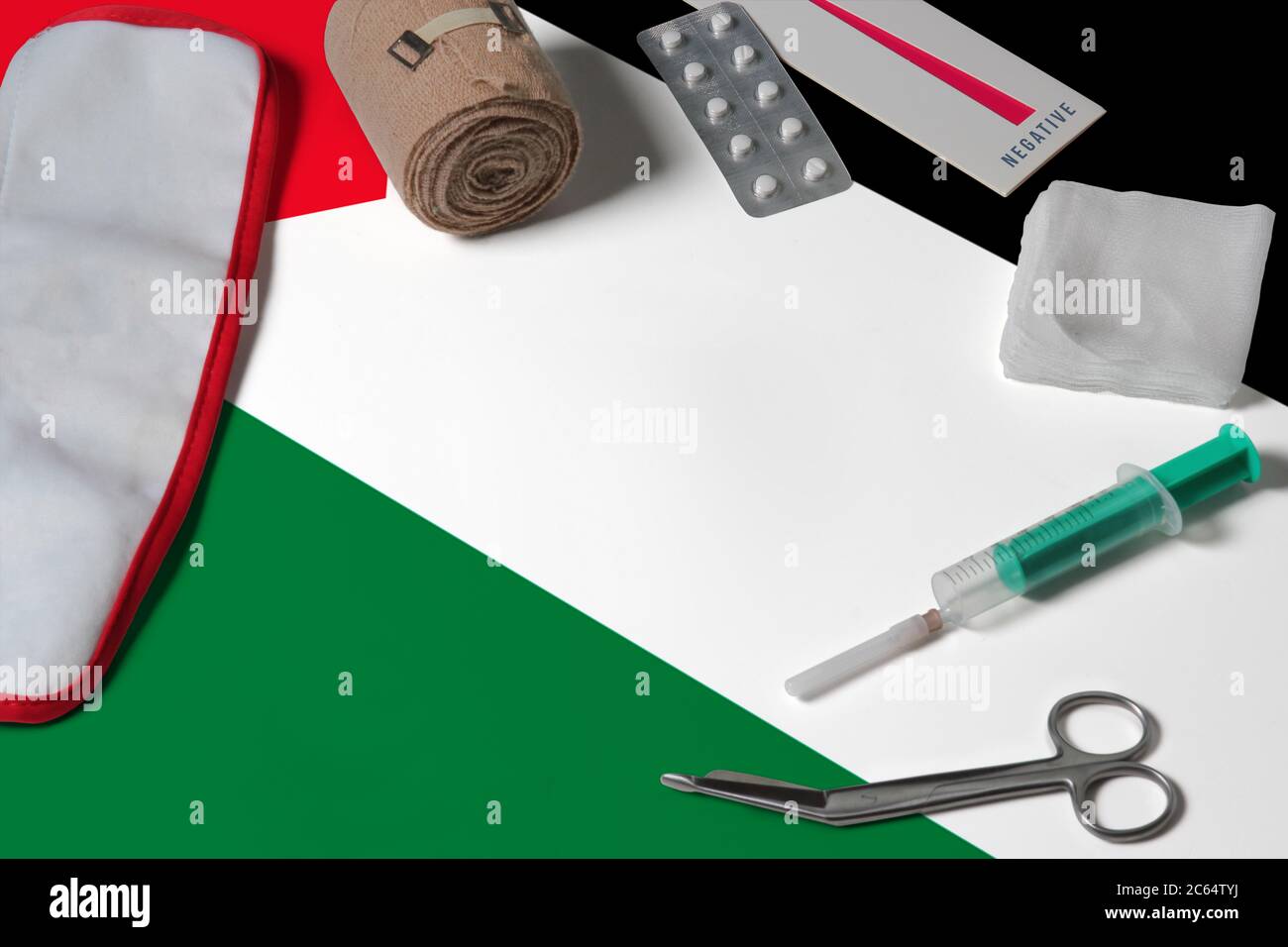 Palestine flag with first aid medical kit on wooden table background