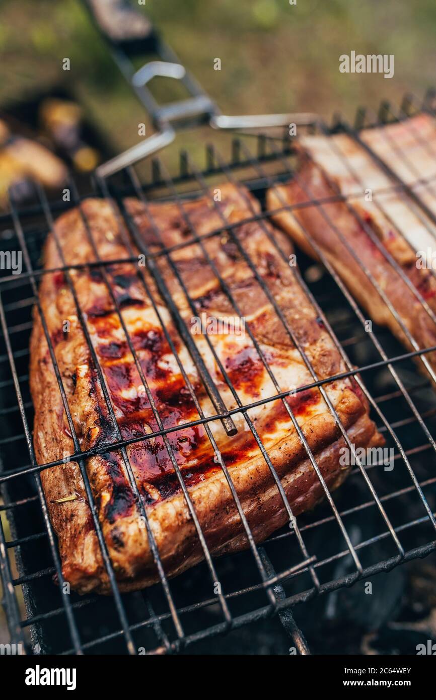 Fat juicy pork ribs on the fire - crispy flavorful cholesterol crust ...