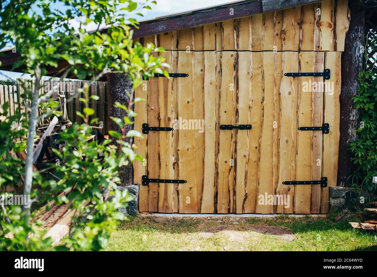 Rural-style unedged board barn gate - rough lumber processing - forged ...