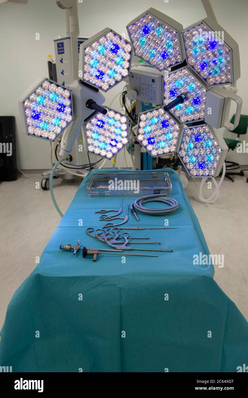 A room used for the preparation of equipment prior to an operation at a hospital. Lights, machines, and surgical instruments are laid out in ready. Stock Photo