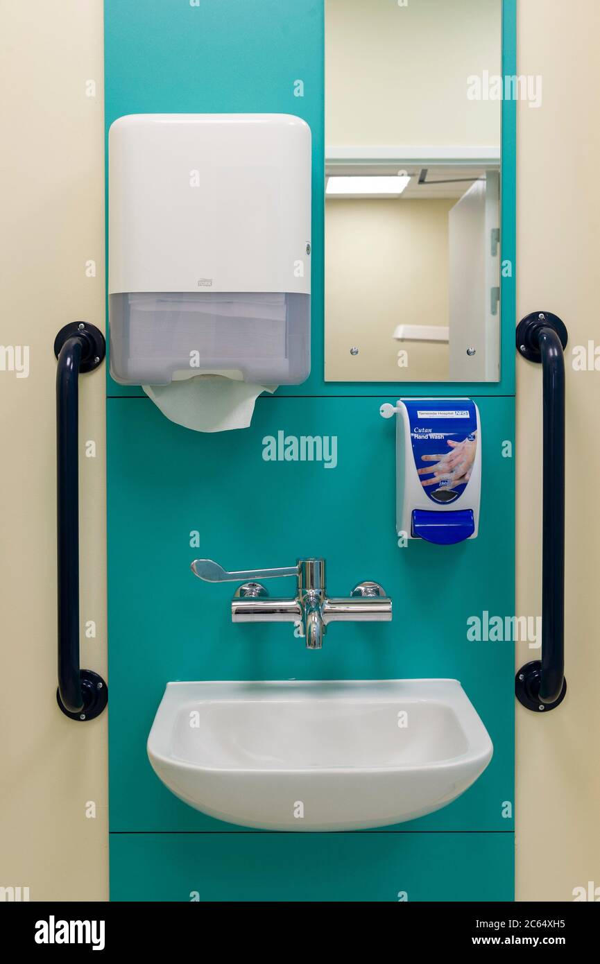 A new hand and body clean station and shower at a hospital. Hand sanitizer and patient grab rails are installed. Stock Photo