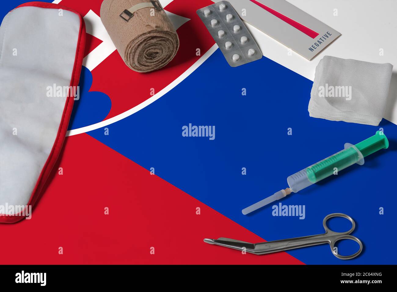 Slovakia flag with first aid medical kit on wooden table background