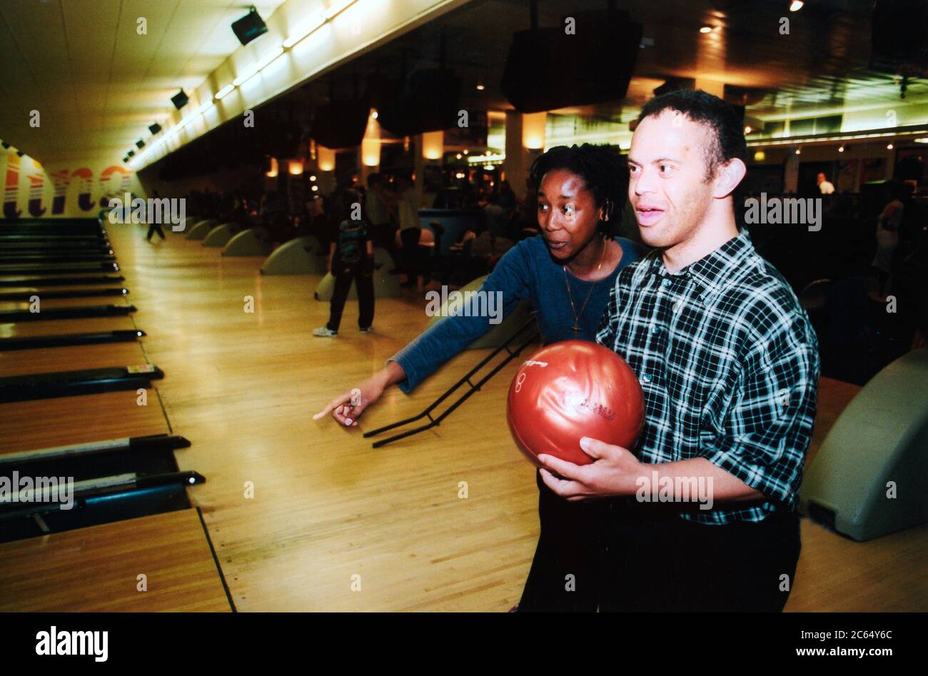 Young people with learning disabilities on social outing playing bowls; Leeds UK Stock Photo