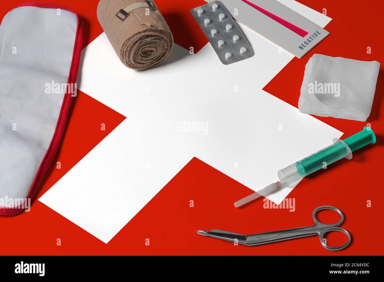Switzerland flag with first aid medical kit on wooden table background.  National healthcare system concept, medical theme Stock Photo - Alamy