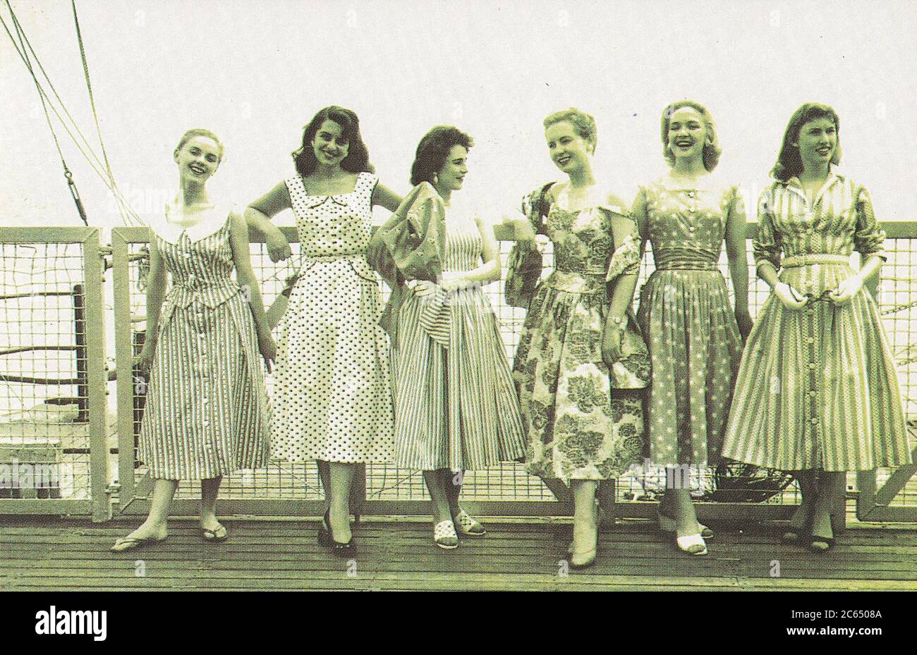Vintage postcard showing young women at Eastbourne, 1956 Stock Photo