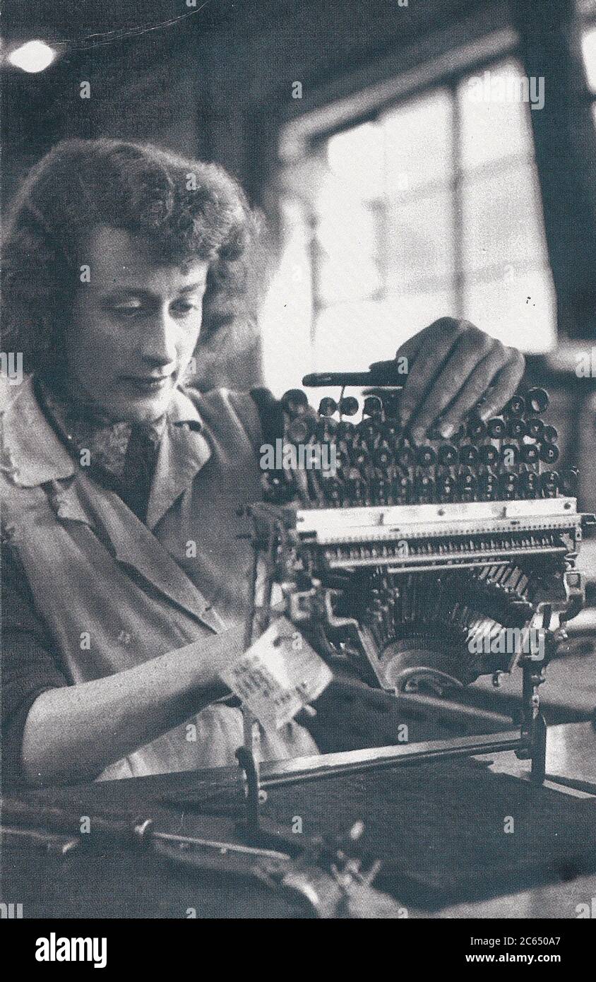 Vintage postcard of woman assembling typewriter at British Olivetti, 1955 Stock Photo