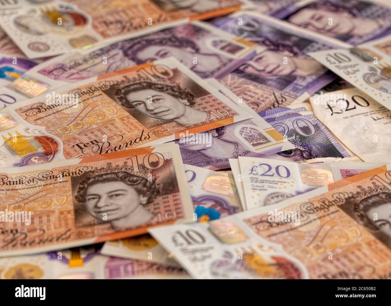 Scattering of ten pound and twenty pound notes facing upwards with