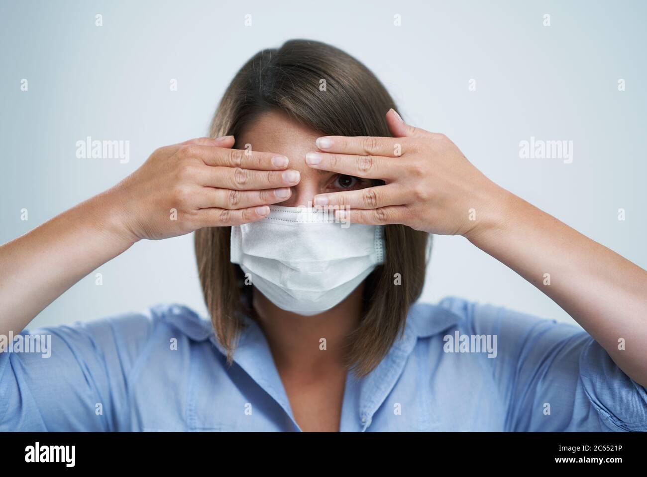 Attractive woman wearing protective mask isolated over white background Stock Photo