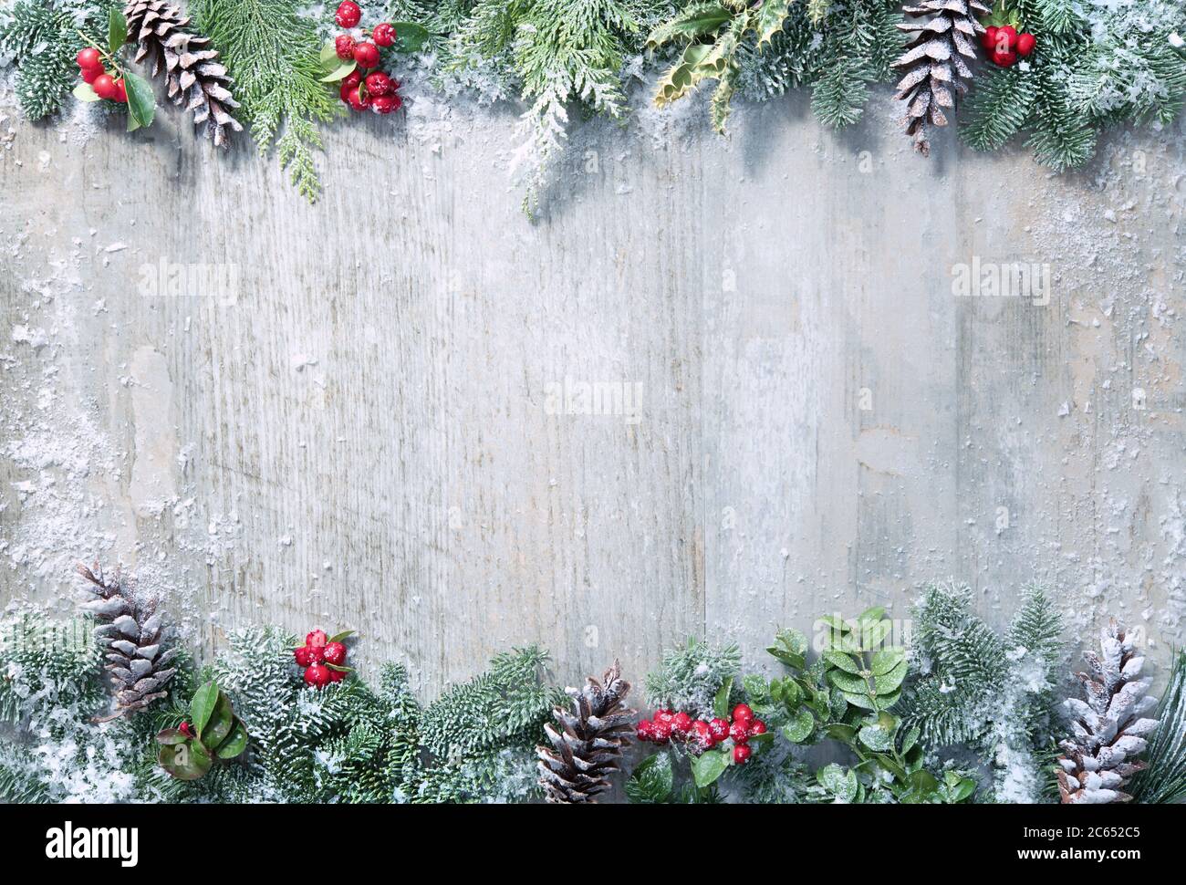 Christmas and New Year background with fir branches, holly and snowfall ...