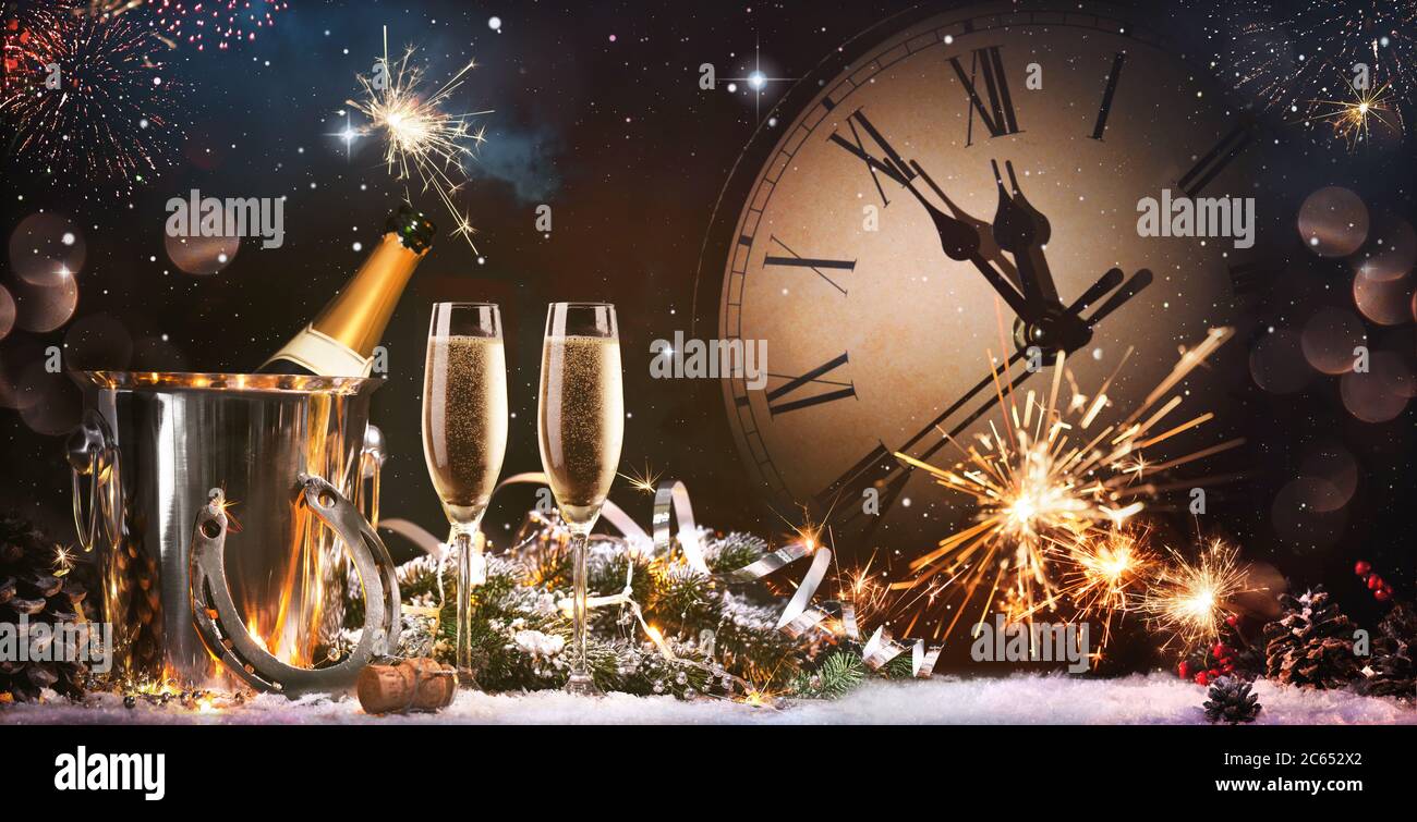 New Years Eve celebration background. Toast with fireworks and champagne at midnight Stock Photo