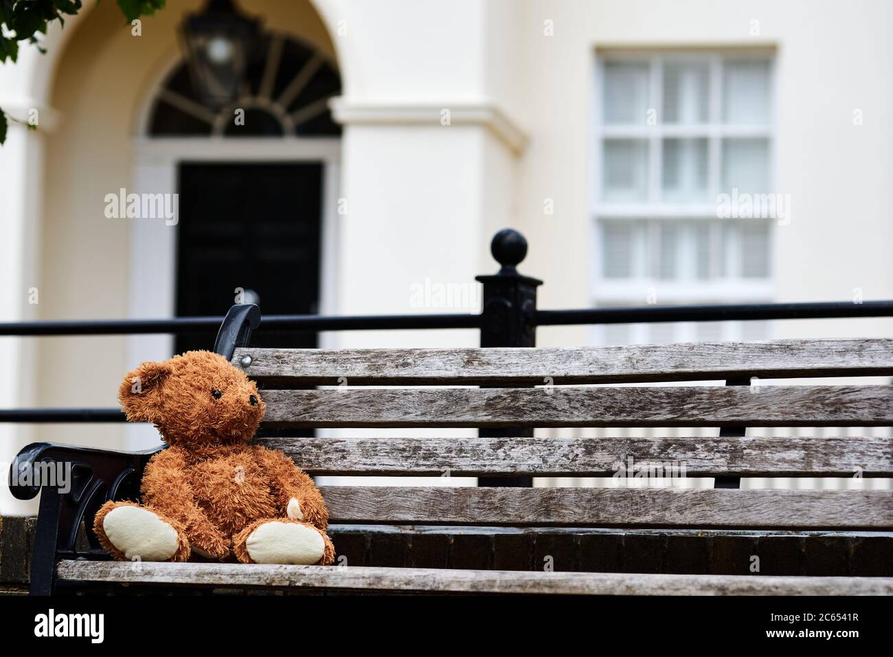 A abandoned or lost teddy bear left on a bench in old Isleworth, London ...