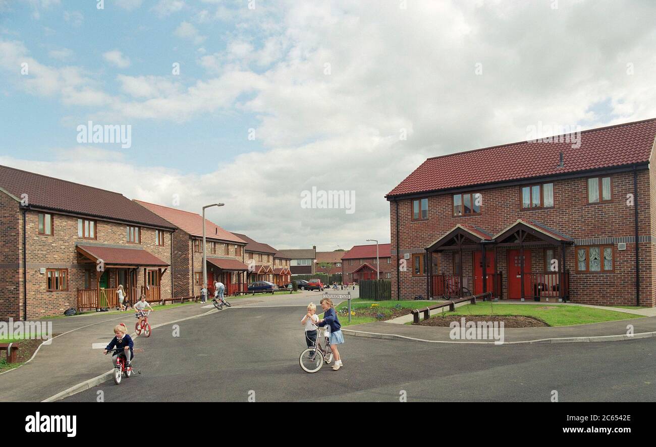 Children playing on bikes in front of their homes hires stock photography and images Alamy