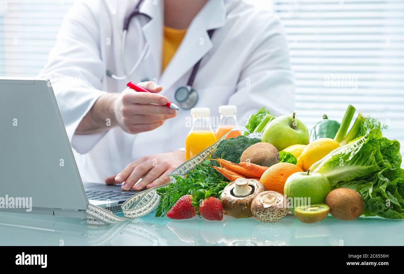 Nutritionist is consulting on healthy eating with fruits and vegetables. Nutrition and diet concept Stock Photo