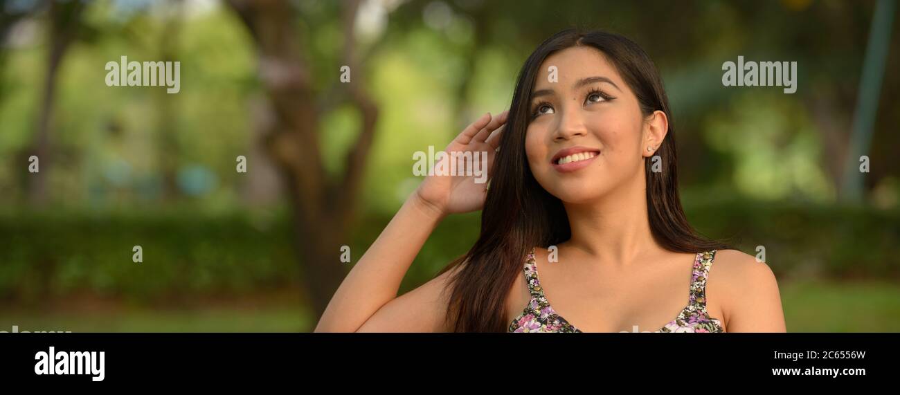 Portrait of young beautiful Asian woman at the park outdoors Stock ...