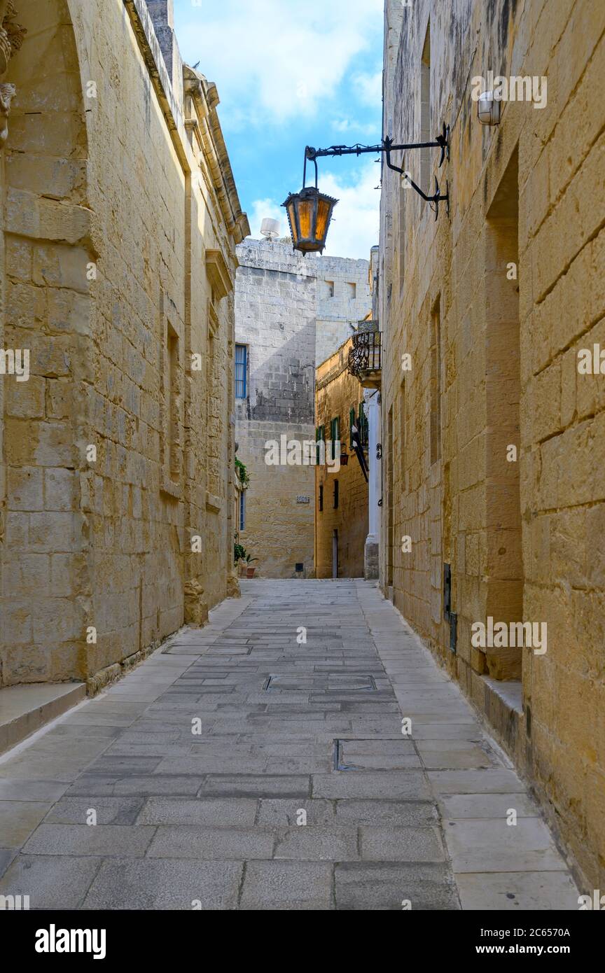 View of one of the many ancient narrow medieval streets in the  town of Mdina, Malta Stock Photo
