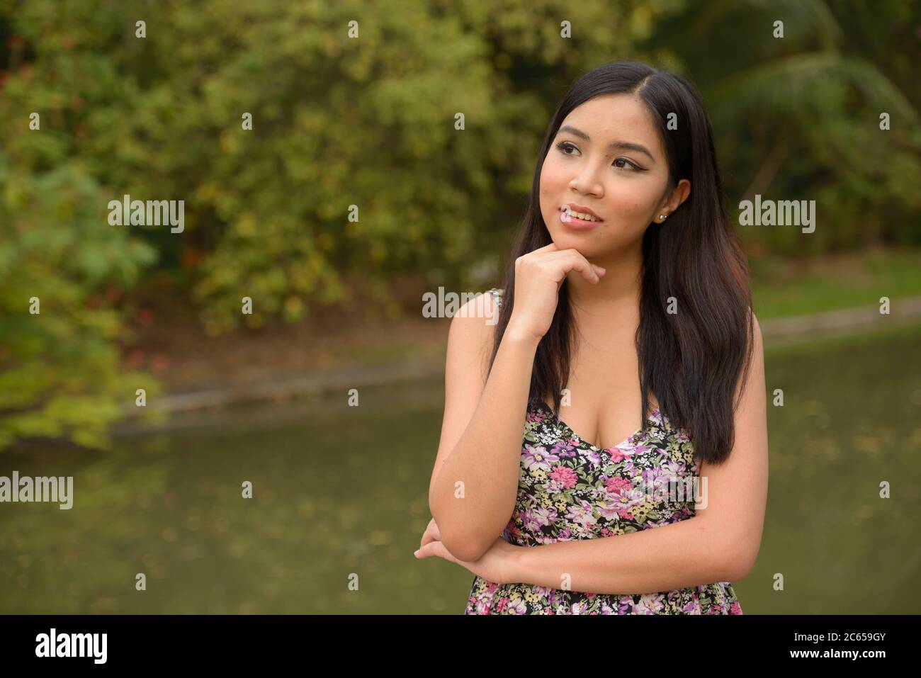 Portrait of young beautiful Asian woman at the park outdoors Stock ...