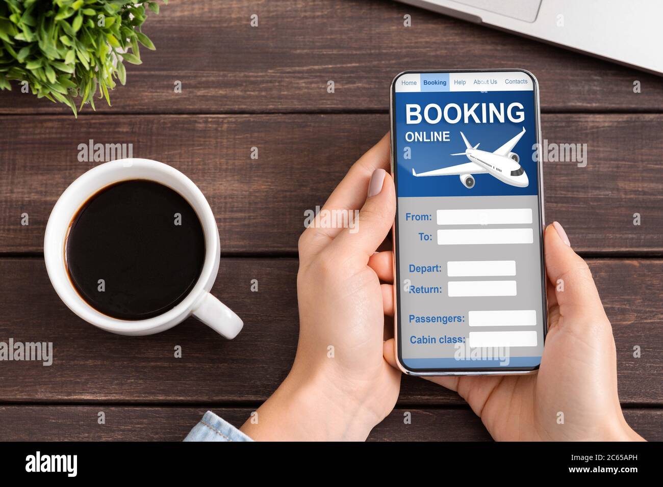 Lady With Smartphone Booking Flight Tickets Sitting At Desk Indoors Stock Photo