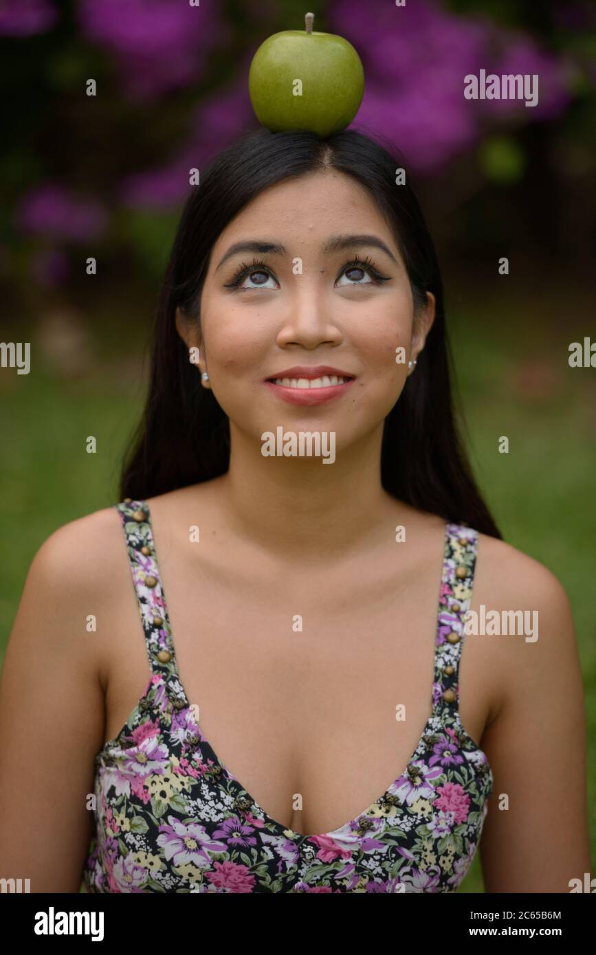 Portrait of young beautiful Asian woman at the park outdoors Stock ...