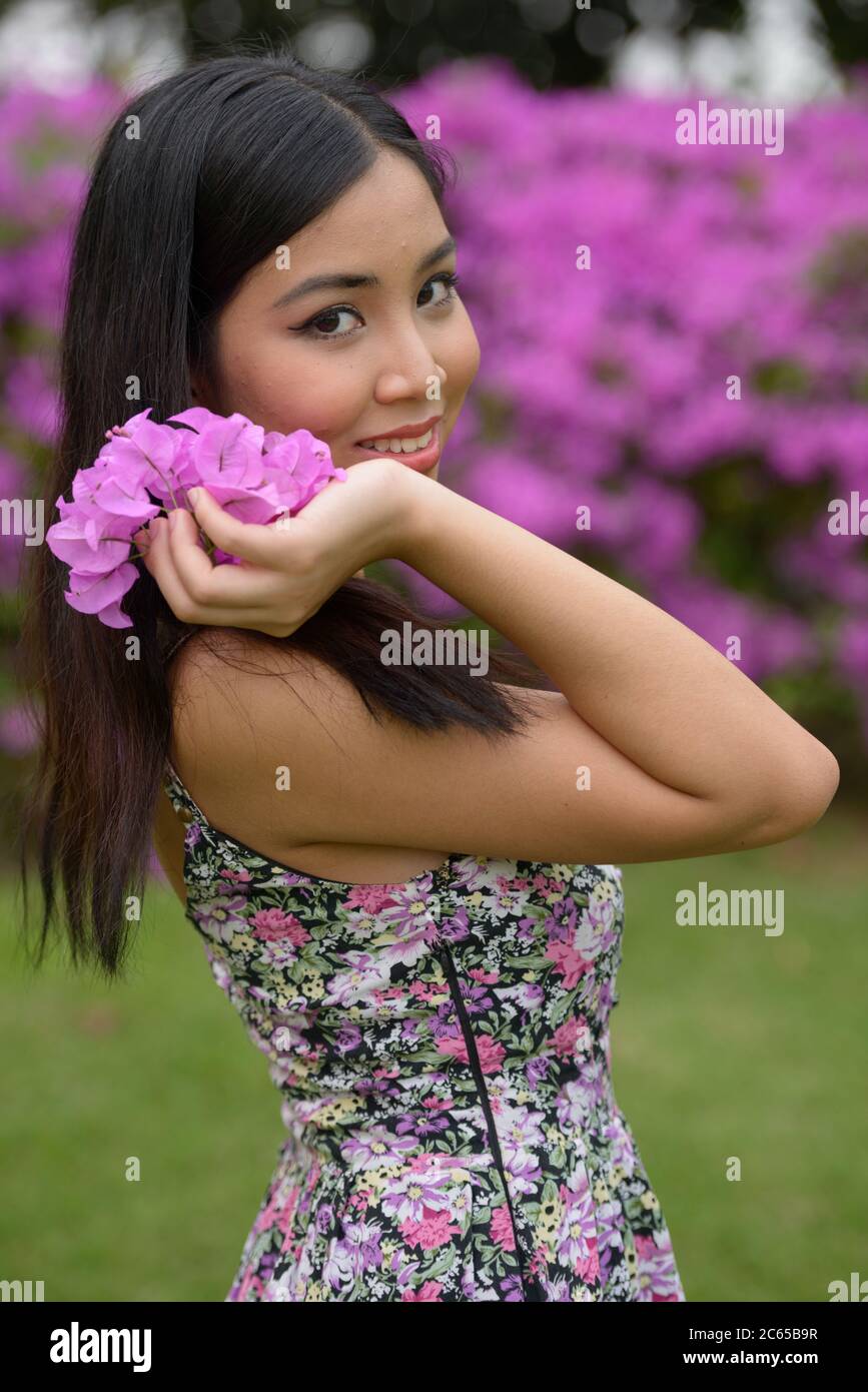 Portrait of young beautiful Asian woman at the park outdoors Stock ...