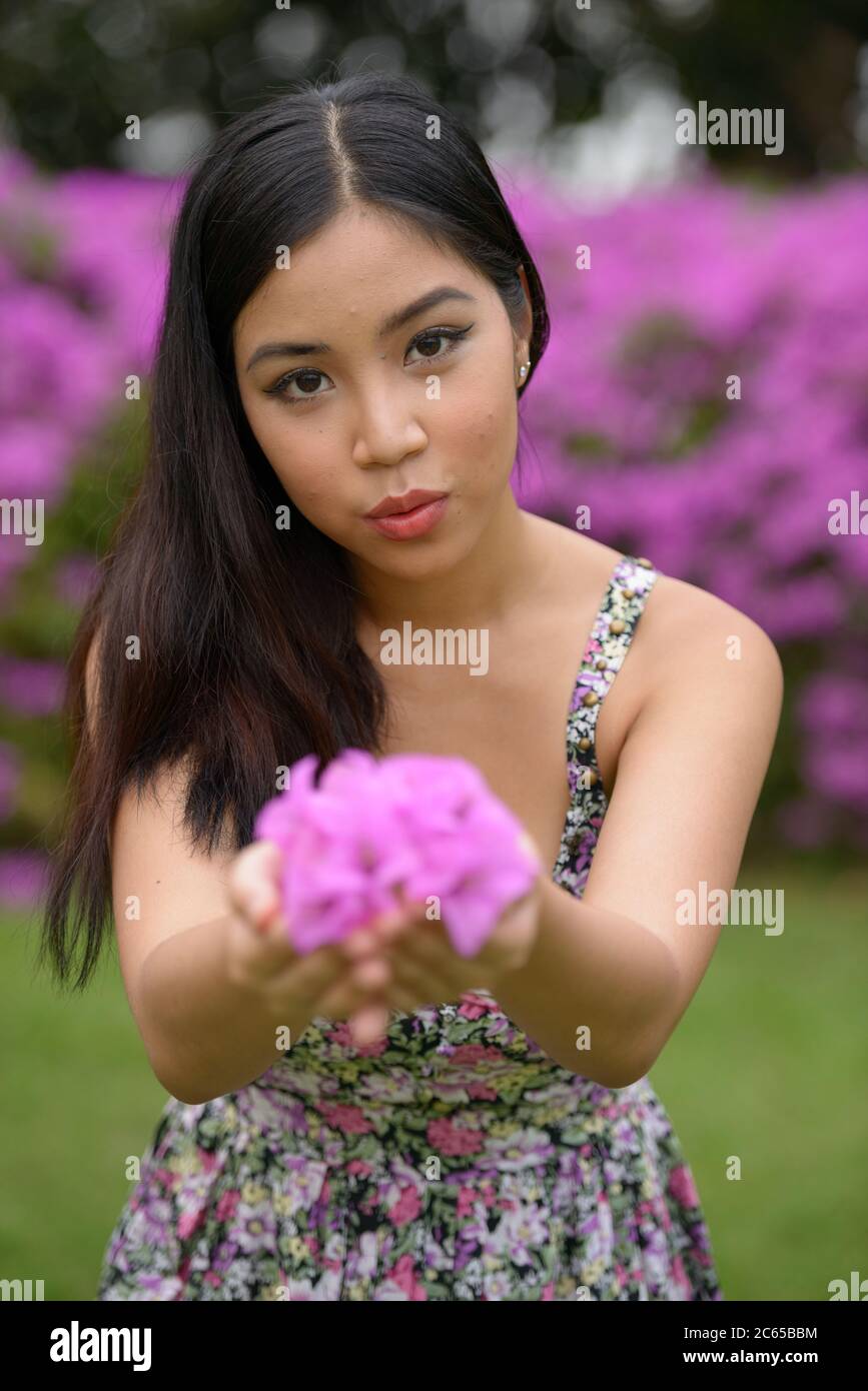 Portrait of young beautiful Asian woman at the park outdoors Stock ...