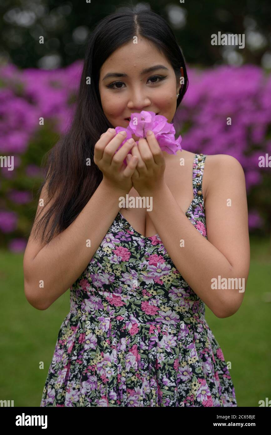 Portrait of young beautiful Asian woman at the park outdoors Stock ...