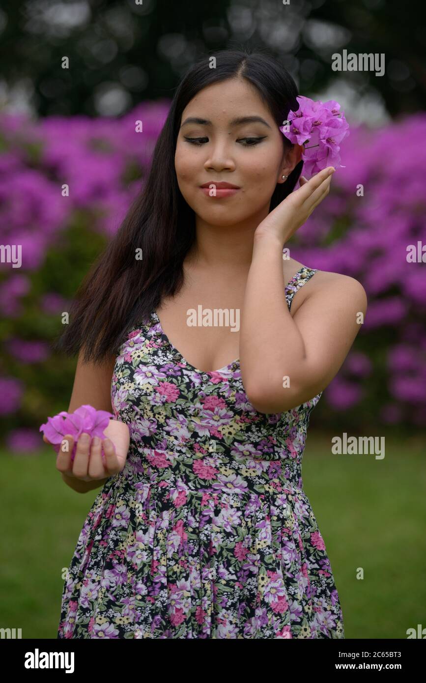 Portrait of young beautiful Asian woman at the park outdoors Stock ...
