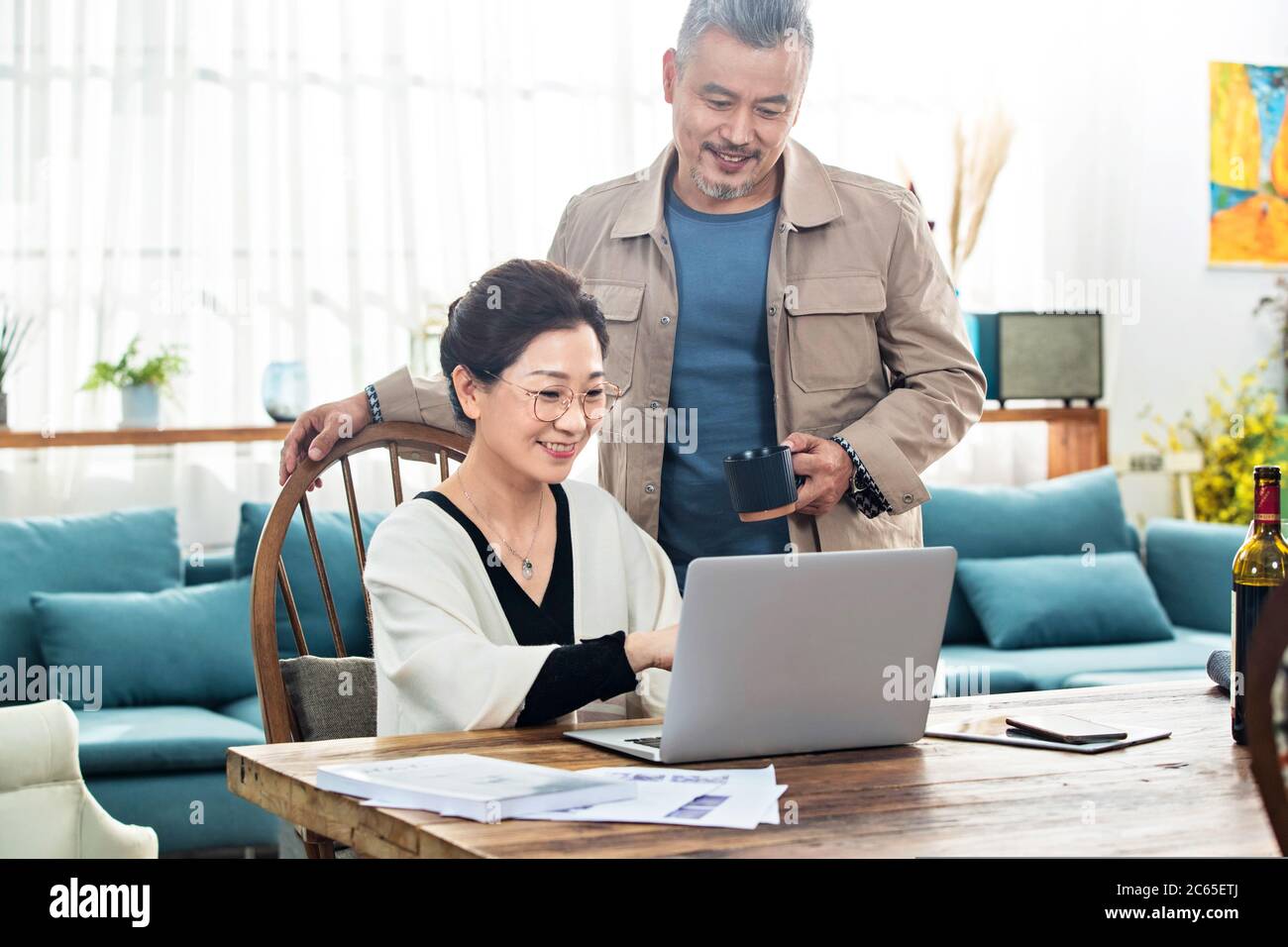Happy old couple using laptop at home Stock Photo