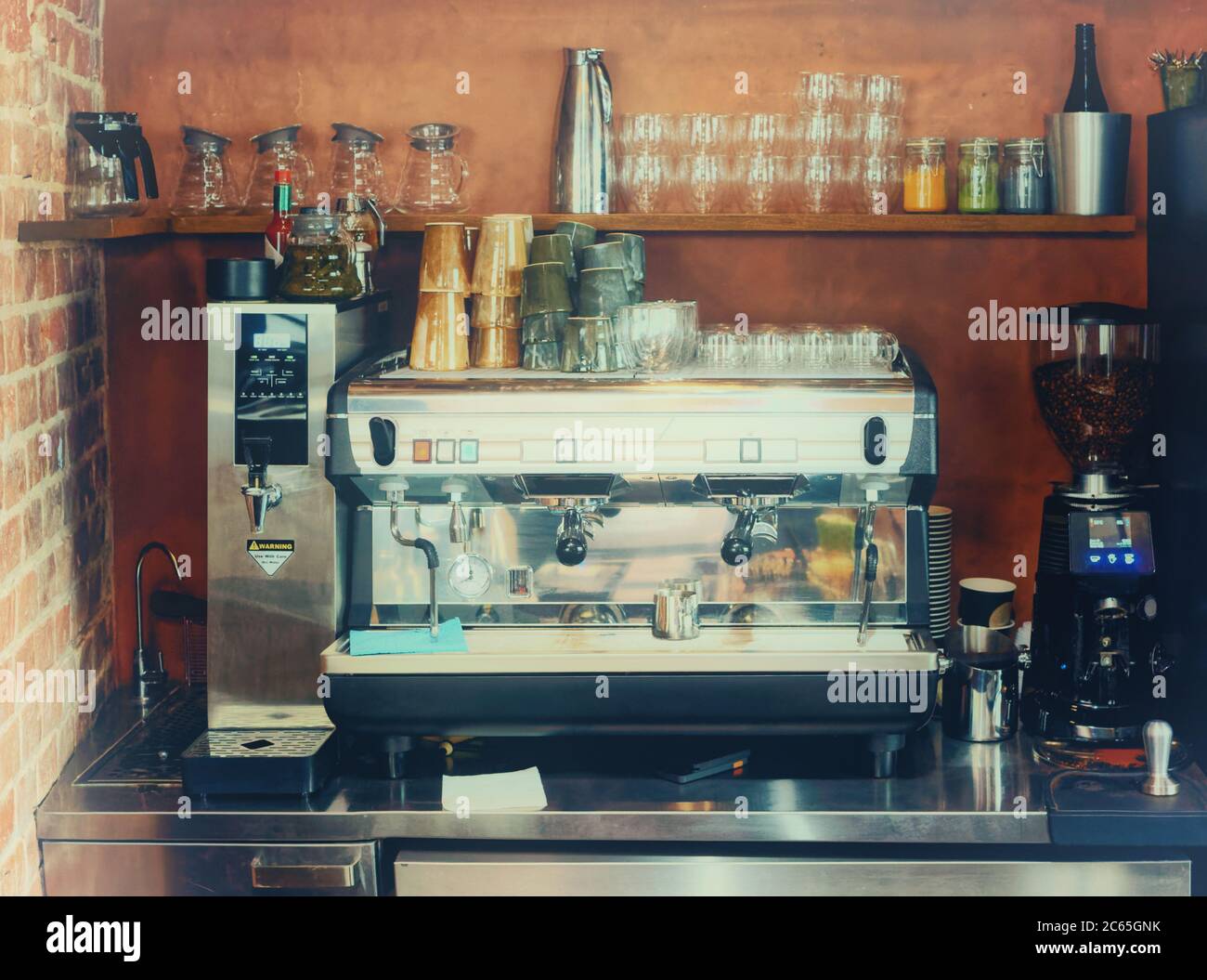https://c8.alamy.com/comp/2C65GNK/espresso-machine-hot-water-dispenser-and-coffee-grinder-in-a-bar-toned-2C65GNK.jpg