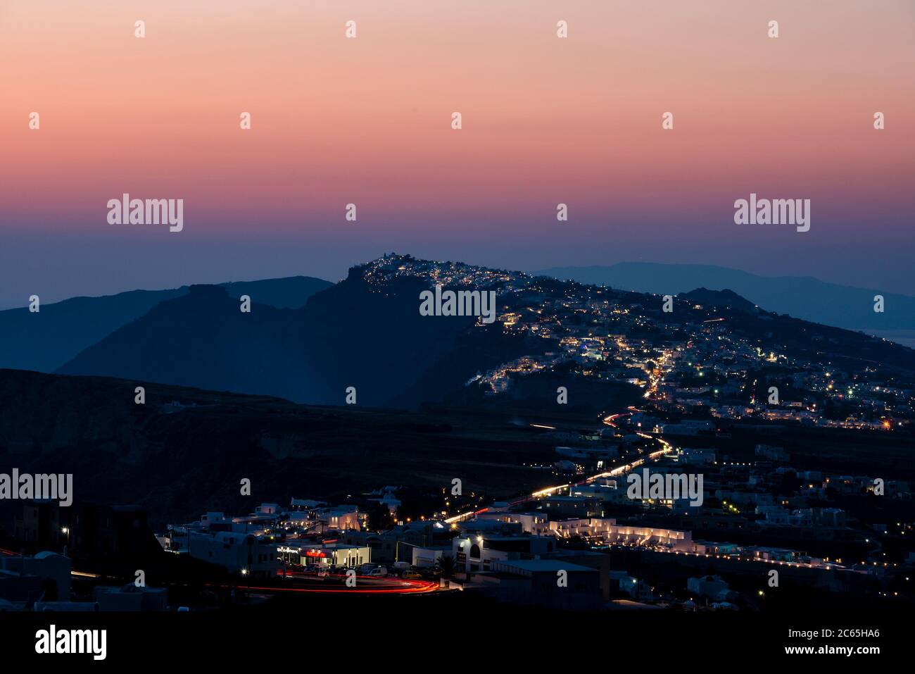 the caldera of Santorini with the city of Fira in the foreground shots from the hilltop village of Pyrgos at sunset Stock Photo