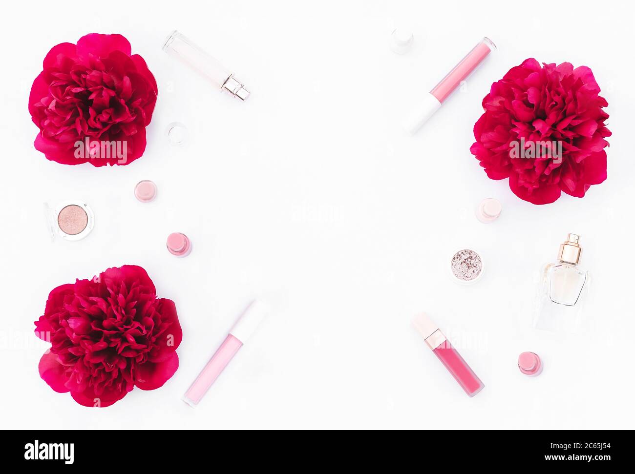 Trendy design template with pink cosmetics layout decorated with wine red peonies on white background. Flat lay style. Copy space. Mockup for your design. Stock Photo