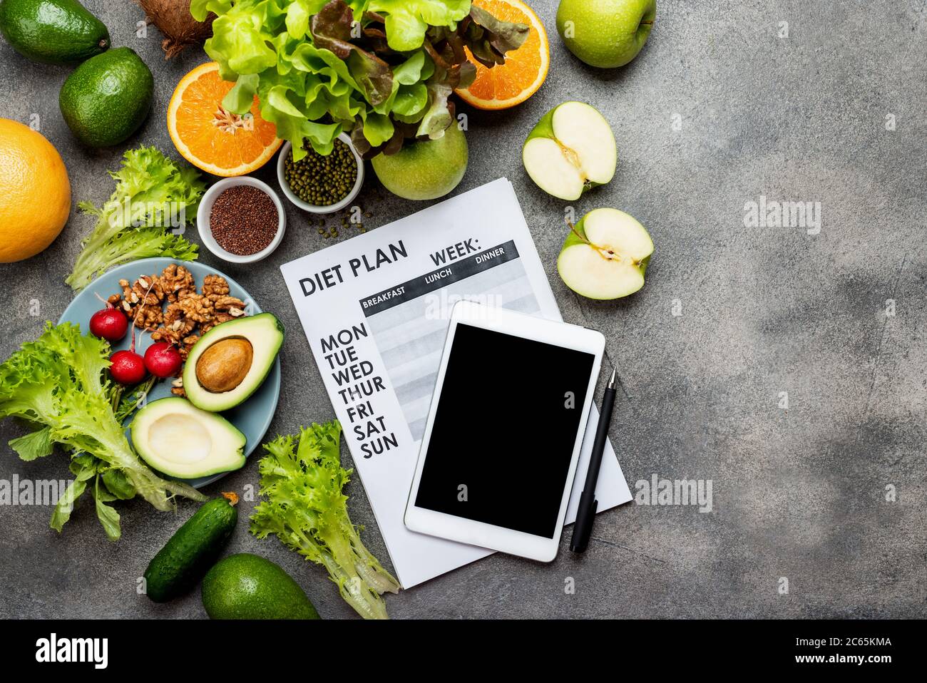 Calories counting , diet , food control and weight loss concept. woman  using Calorie counter application on tablet at dining table with fresh  vegetabl Stock Photo - Alamy