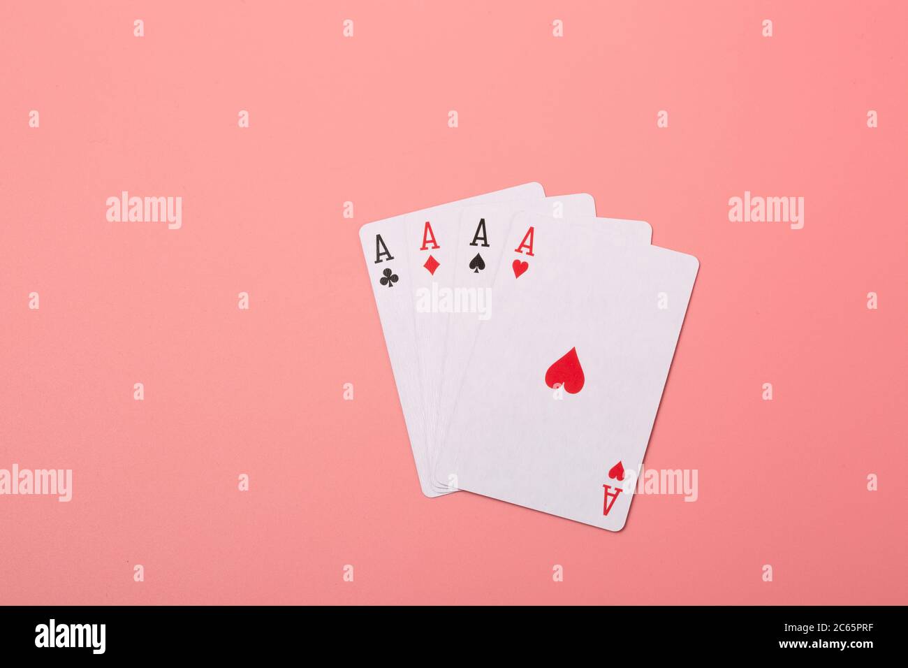 Expanded playing cards on pink background Stock Photo