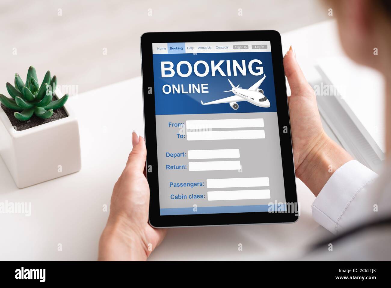 Businesswoman With Digital Tablet Booking Flight Online In Office, Cropped Stock Photo