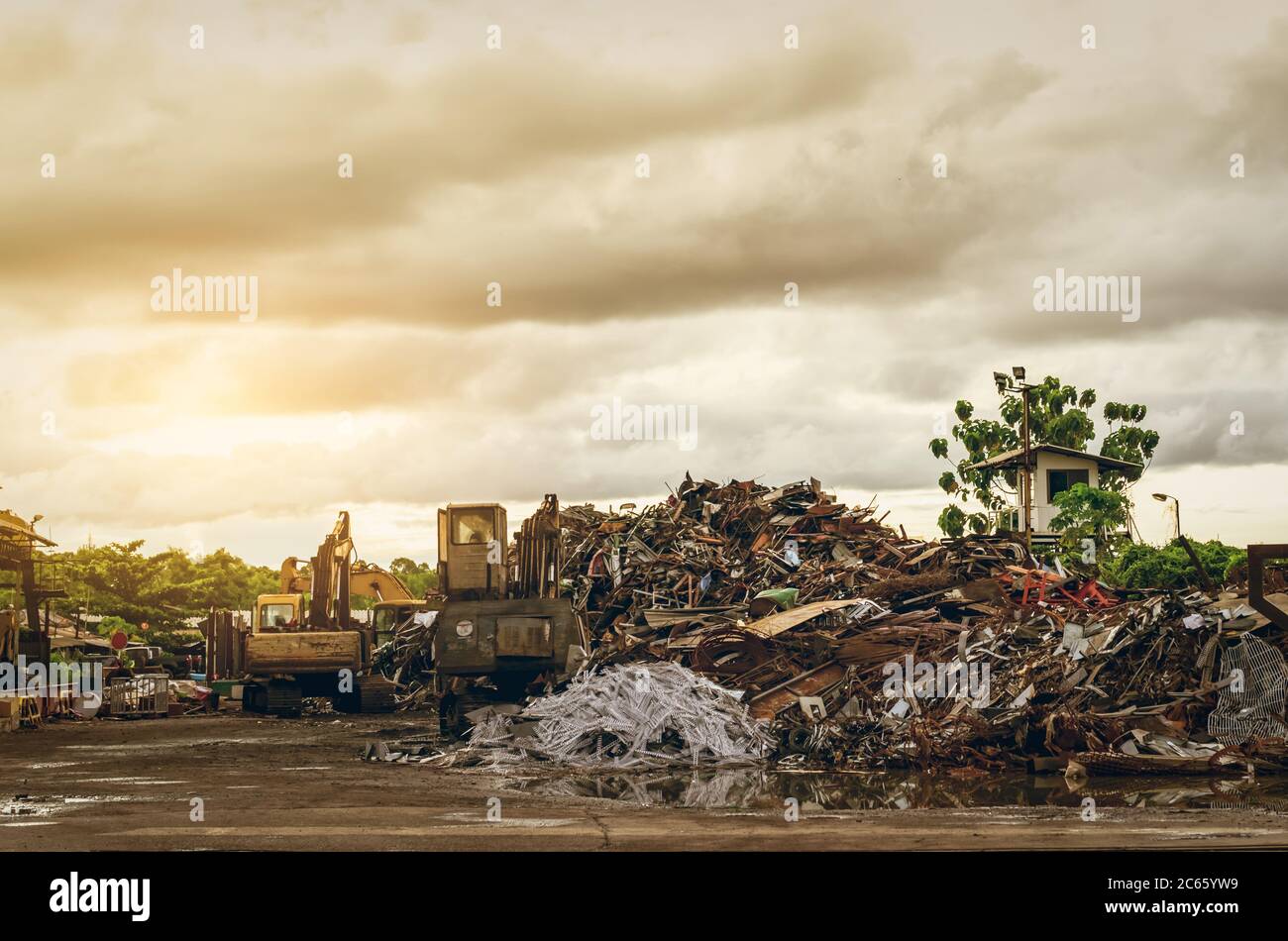 Pile of garbage and backhoe at waste depot. Rubbish recycling business