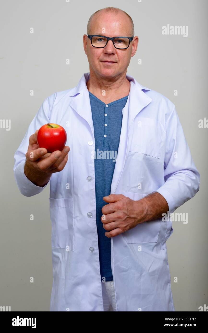 Portrait of mature handsome man doctor with eyeglasses Stock Photo - Alamy
