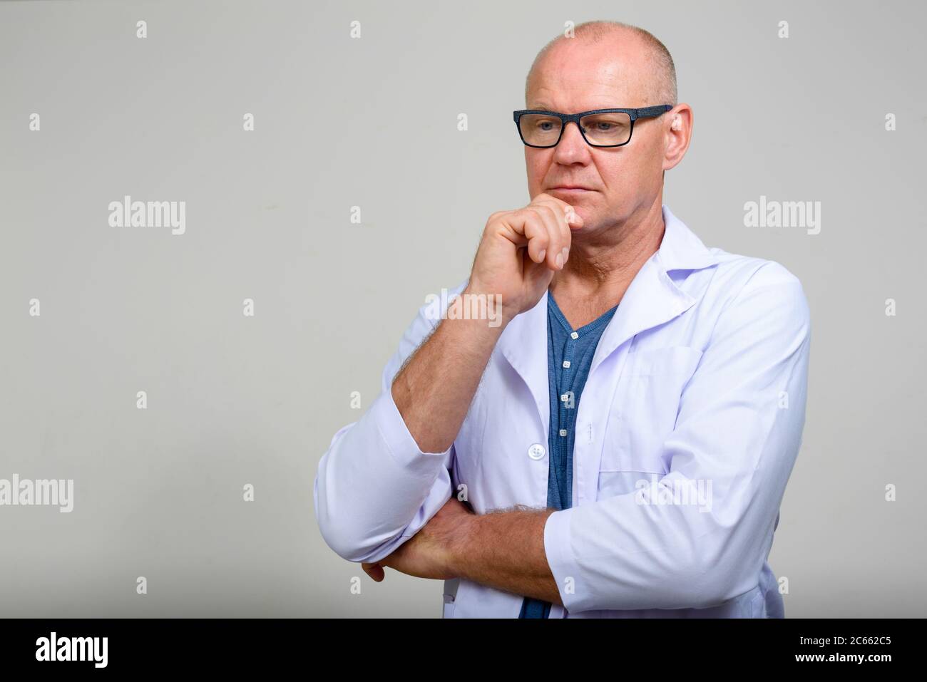 Portrait of mature handsome man doctor with eyeglasses Stock Photo - Alamy