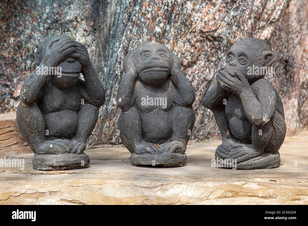 Small statues of the three wise monkeys known as Mazaru, Kikazaru and Iwazaru, embodying the proverb 'see no evil, hear no evil, speak no evil'. Stock Photo