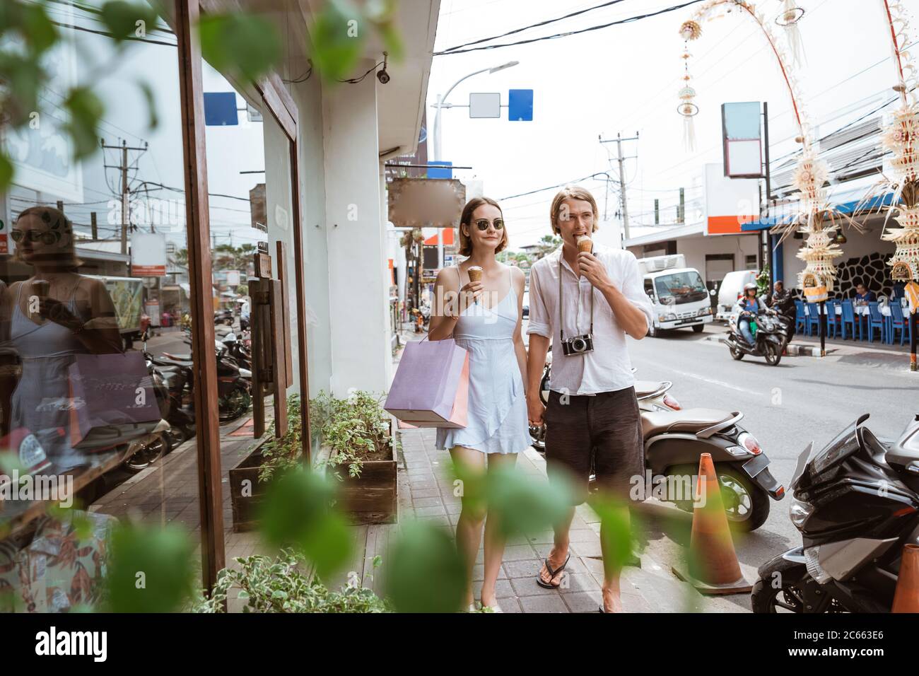 summer holiday of a attractive tourist couple walking on shopping centre in asia Stock Photo