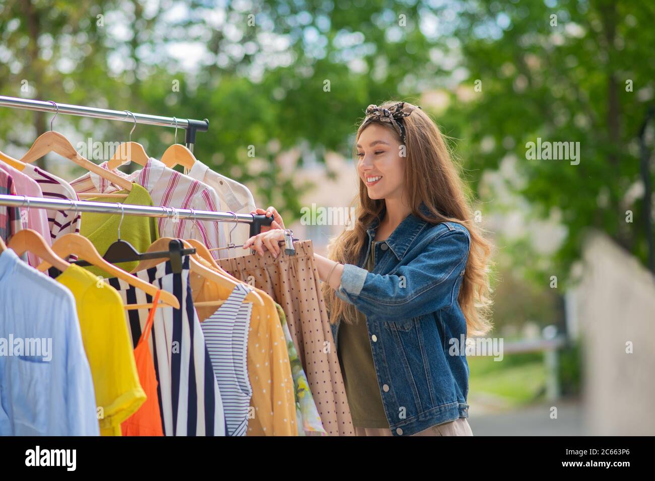 Pretty attractive woman choosing stylish clothes for herself Stock Photo