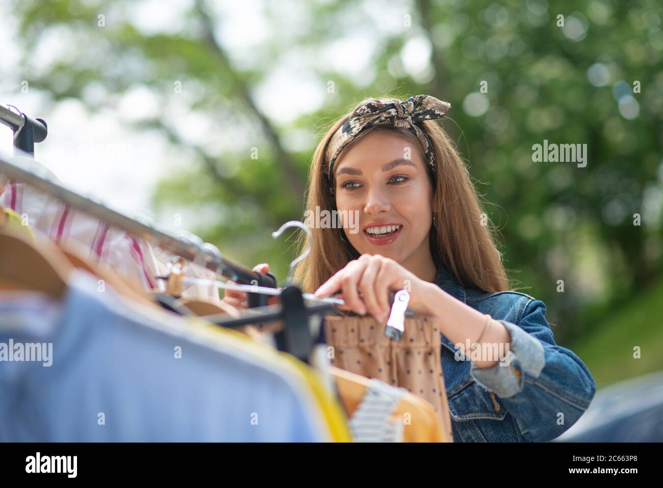 Positive optimistic woman holding a hanger with the skirt Stock Photo