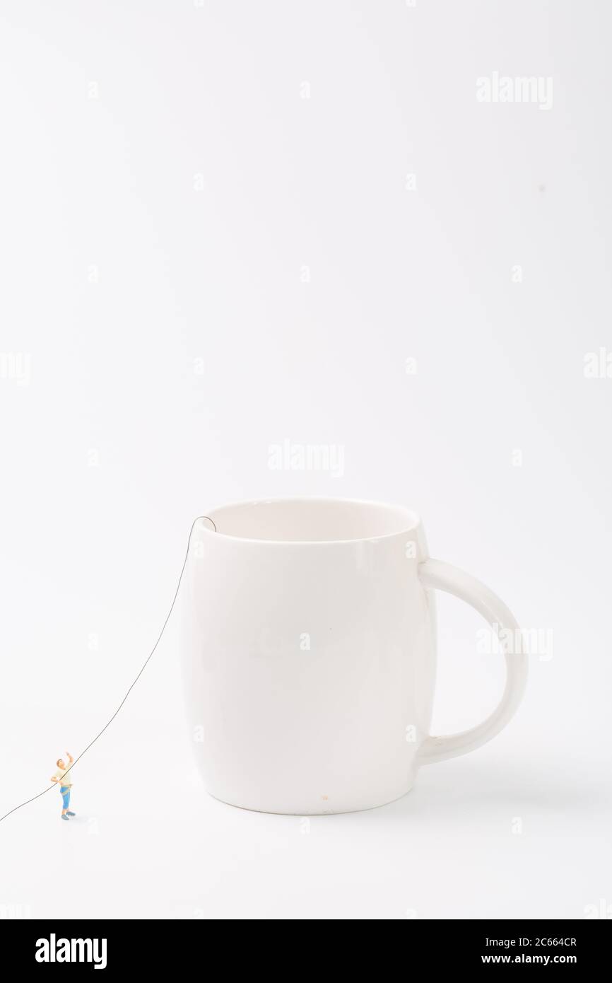 Man climbing cup on white background Stock Photo