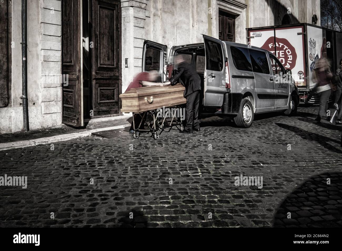 Dead man pushed into hearse in coffin, Rome, Italy Stock Photo