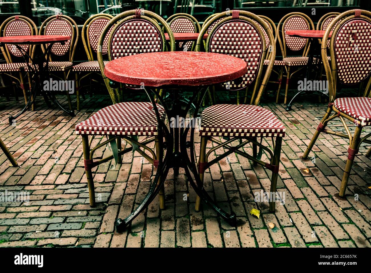 Rainy cafe table and chairs in Amsterdam, Holland, Netherlands Stock Photo