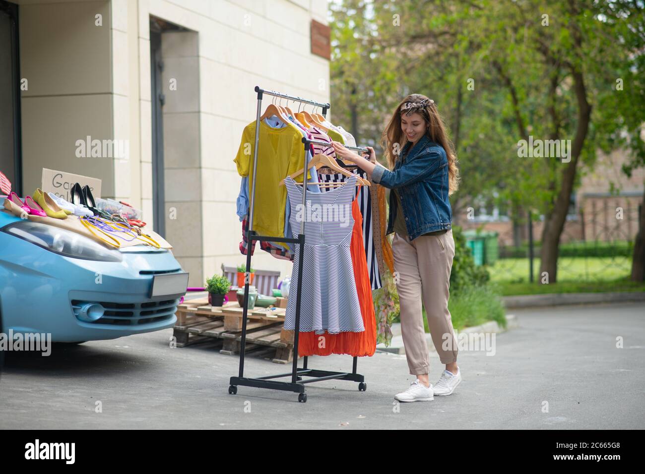 Positive young woman getting ready for the sale Stock Photo