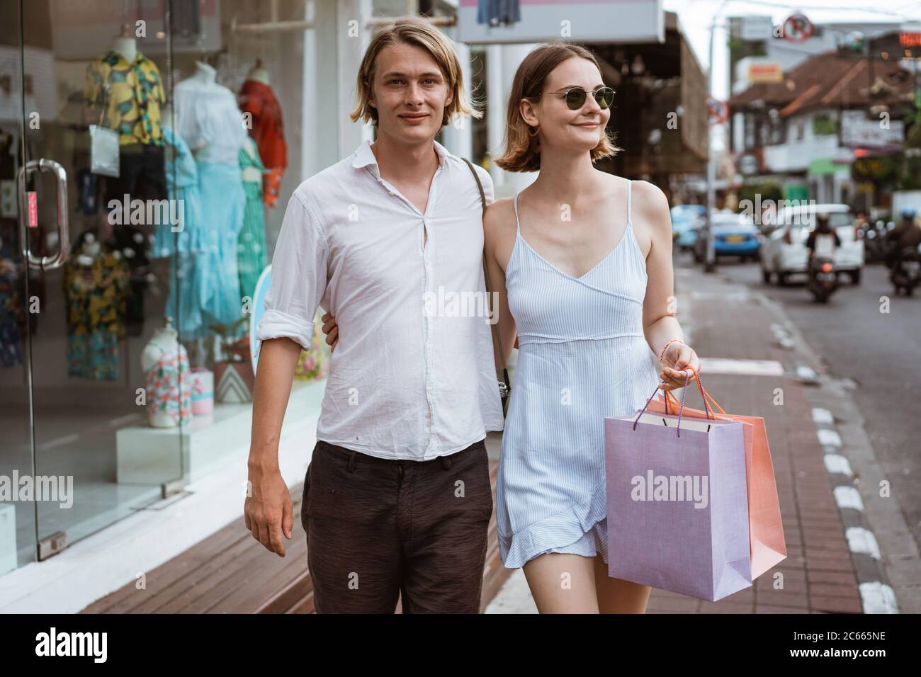 summer holiday of a attractive tourist couple walking on shopping centre in asia Stock Photo